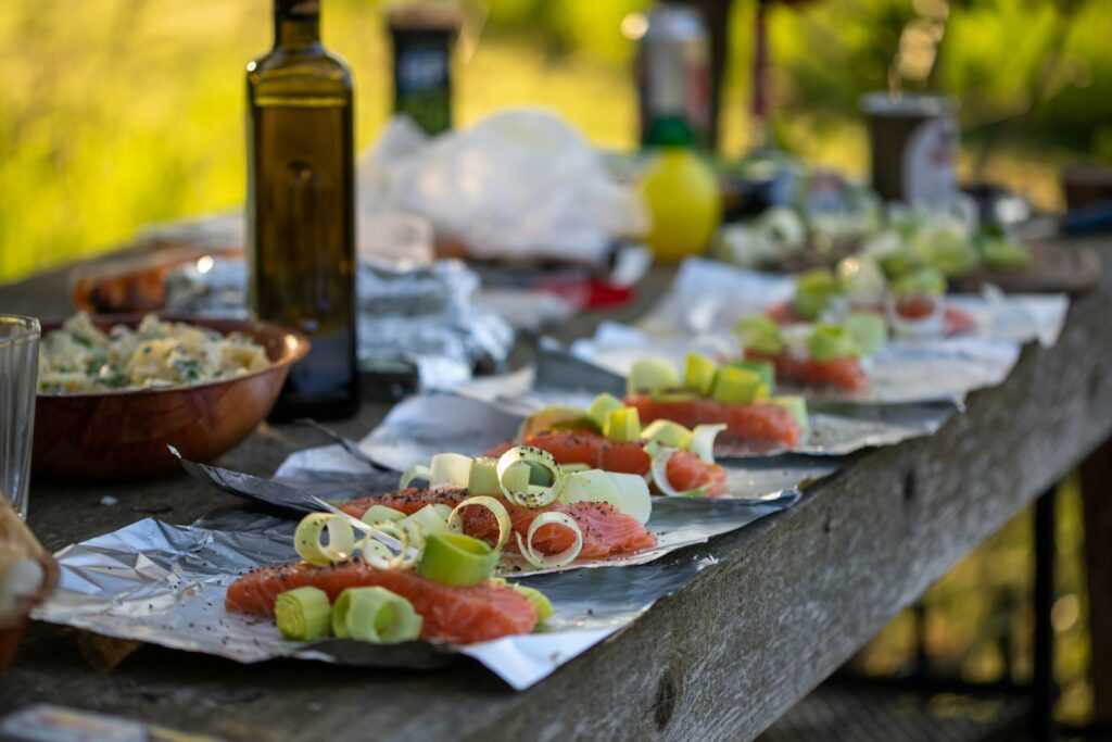 A wooden table topped with plates of food