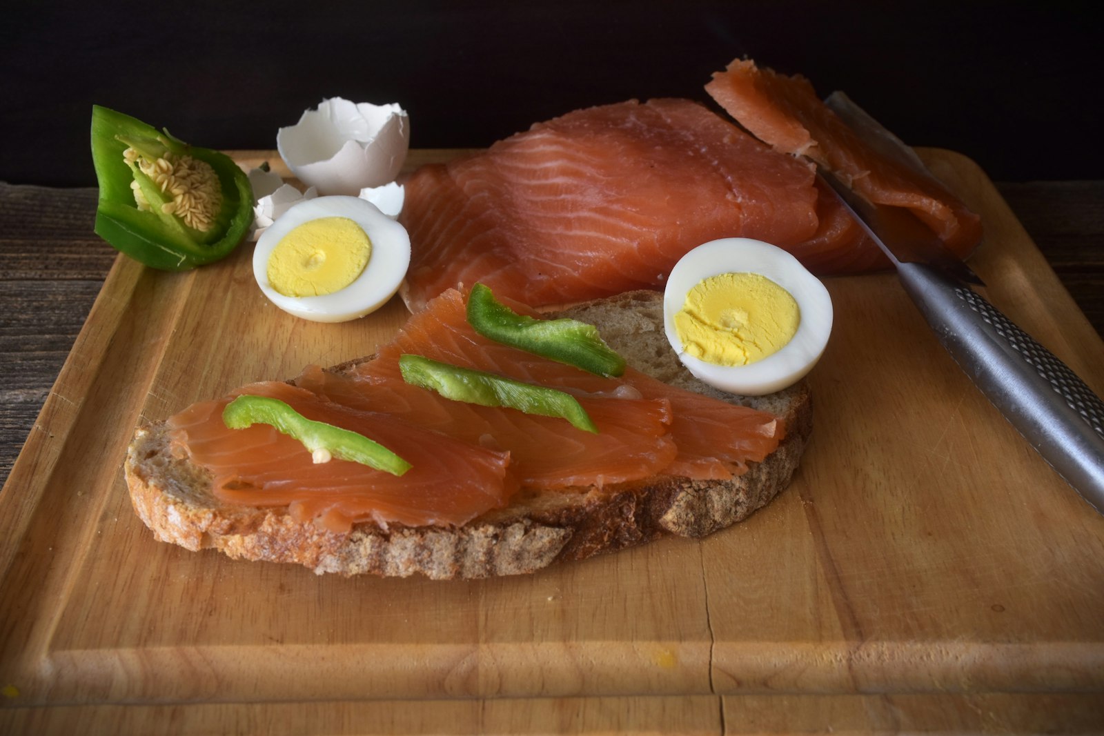 Smoked salmon on rye bread with hard-boiled eggs and peppers